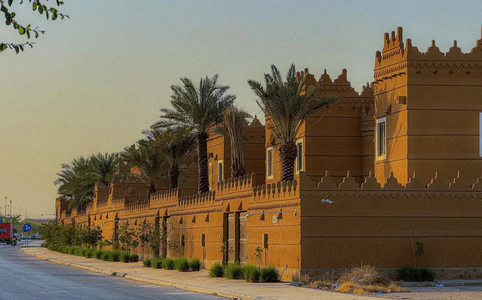 Najdi-style outer walls of the compound at sunset