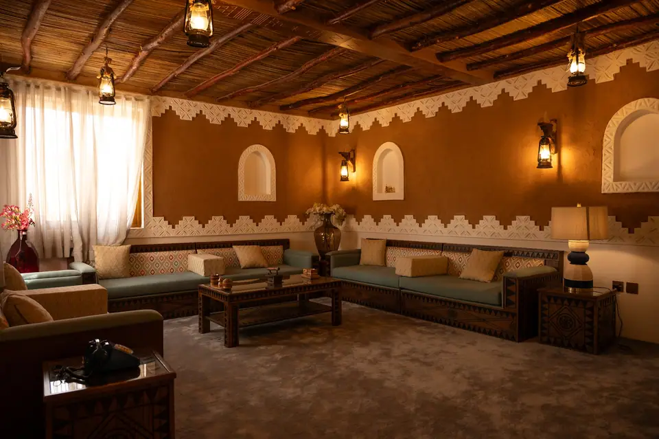 Traditional Najdi majlis with carved ceiling and lanterns
